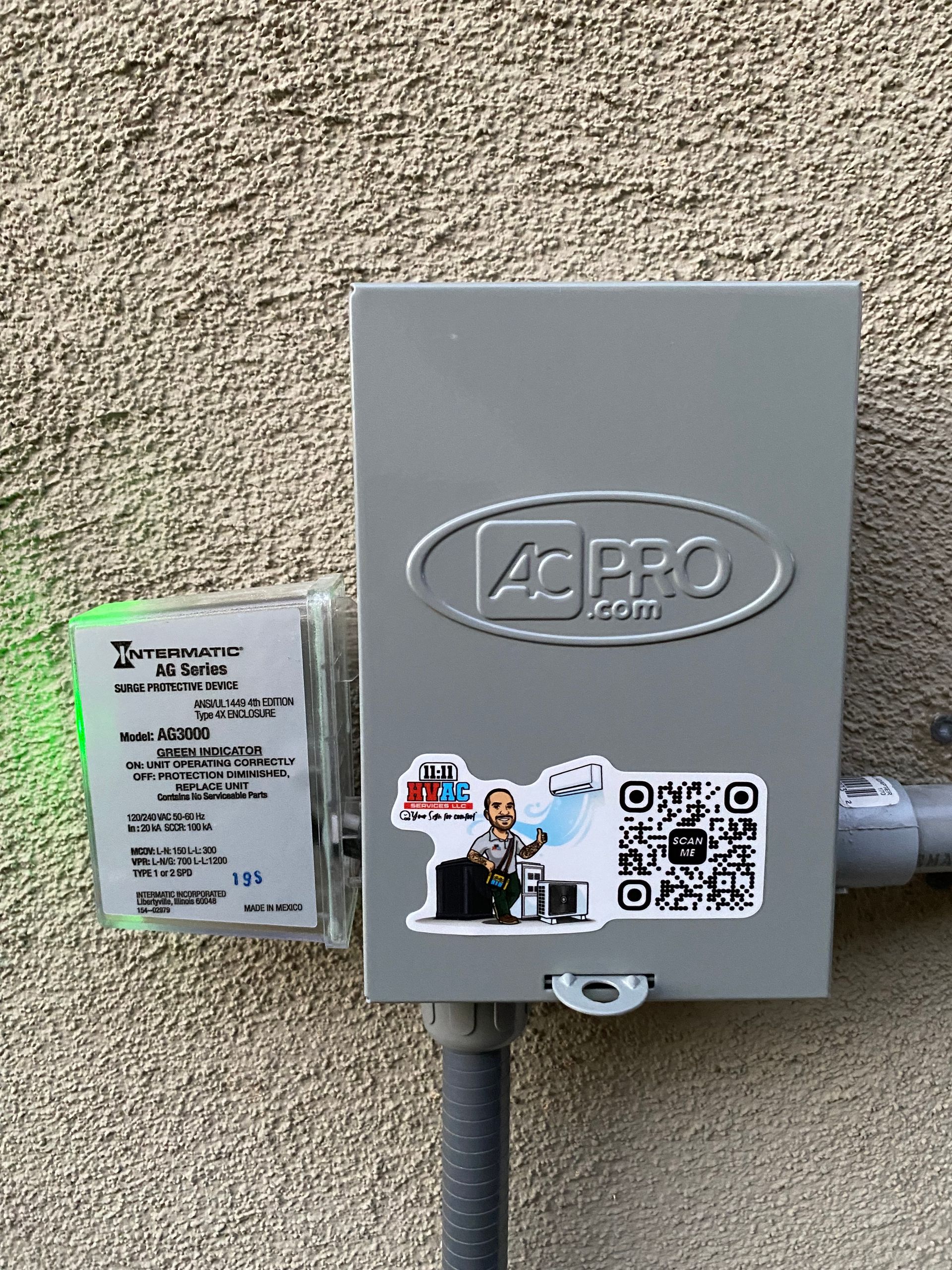 A box with a sticker on it is attached to a wall.