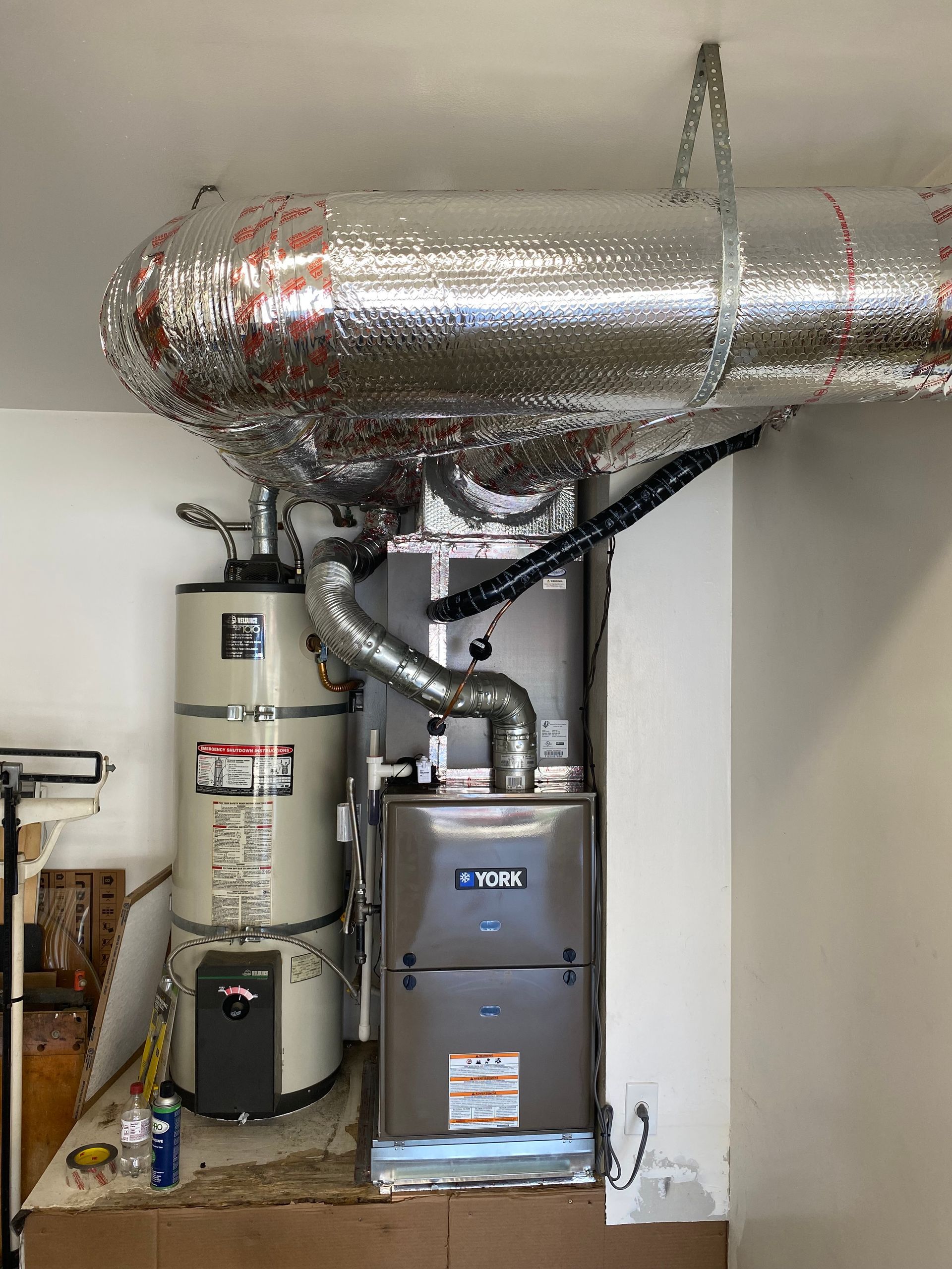 There is a water heater and a furnace in the room.