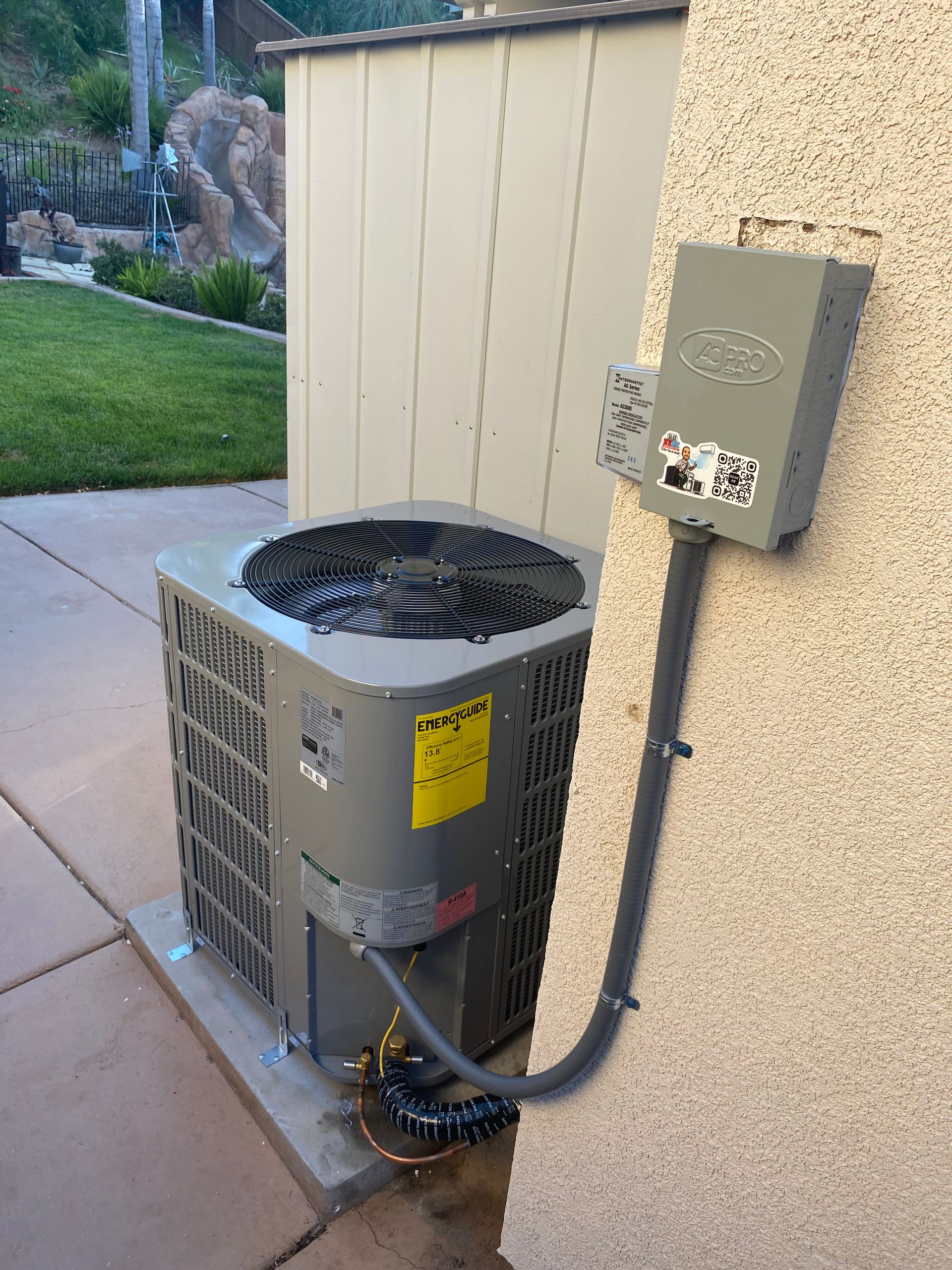 An air conditioner is attached to the side of a building