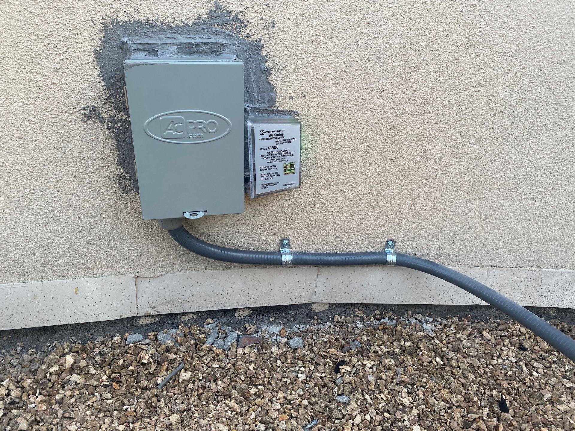 An electrical box is attached to the side of a building.