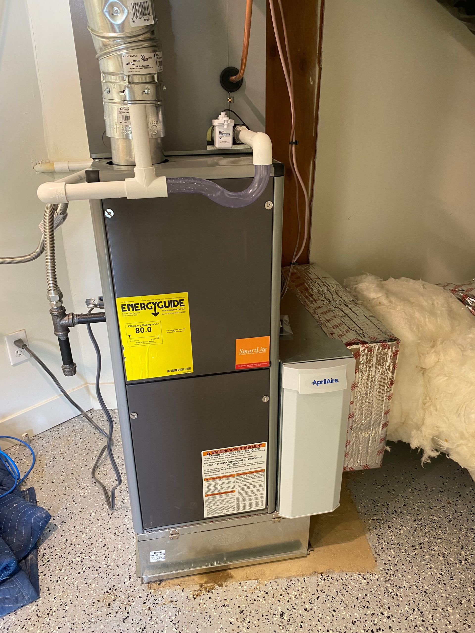 An air conditioner is sitting on the floor in a room.