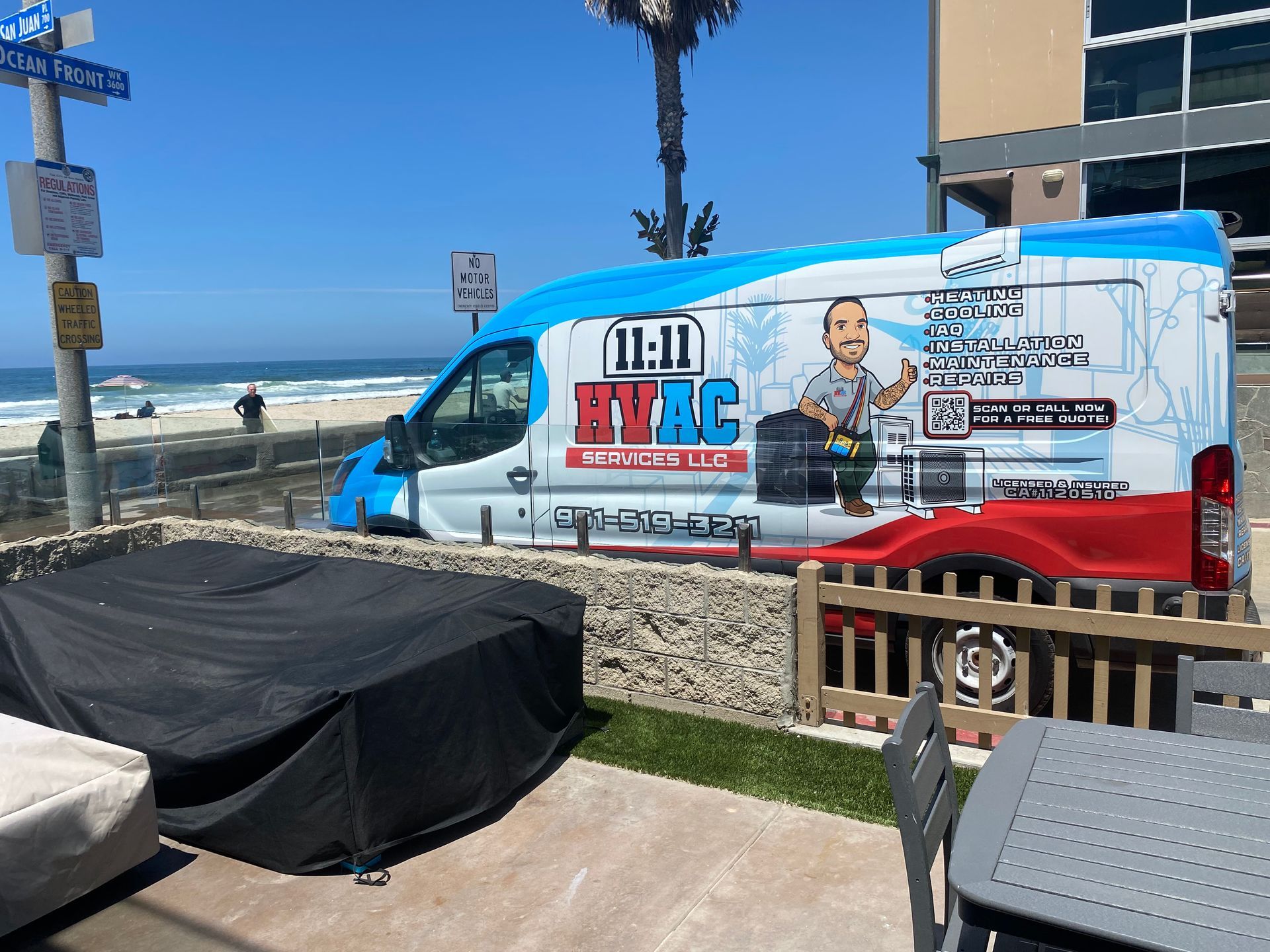 A blue and red van is parked on the side of the road.