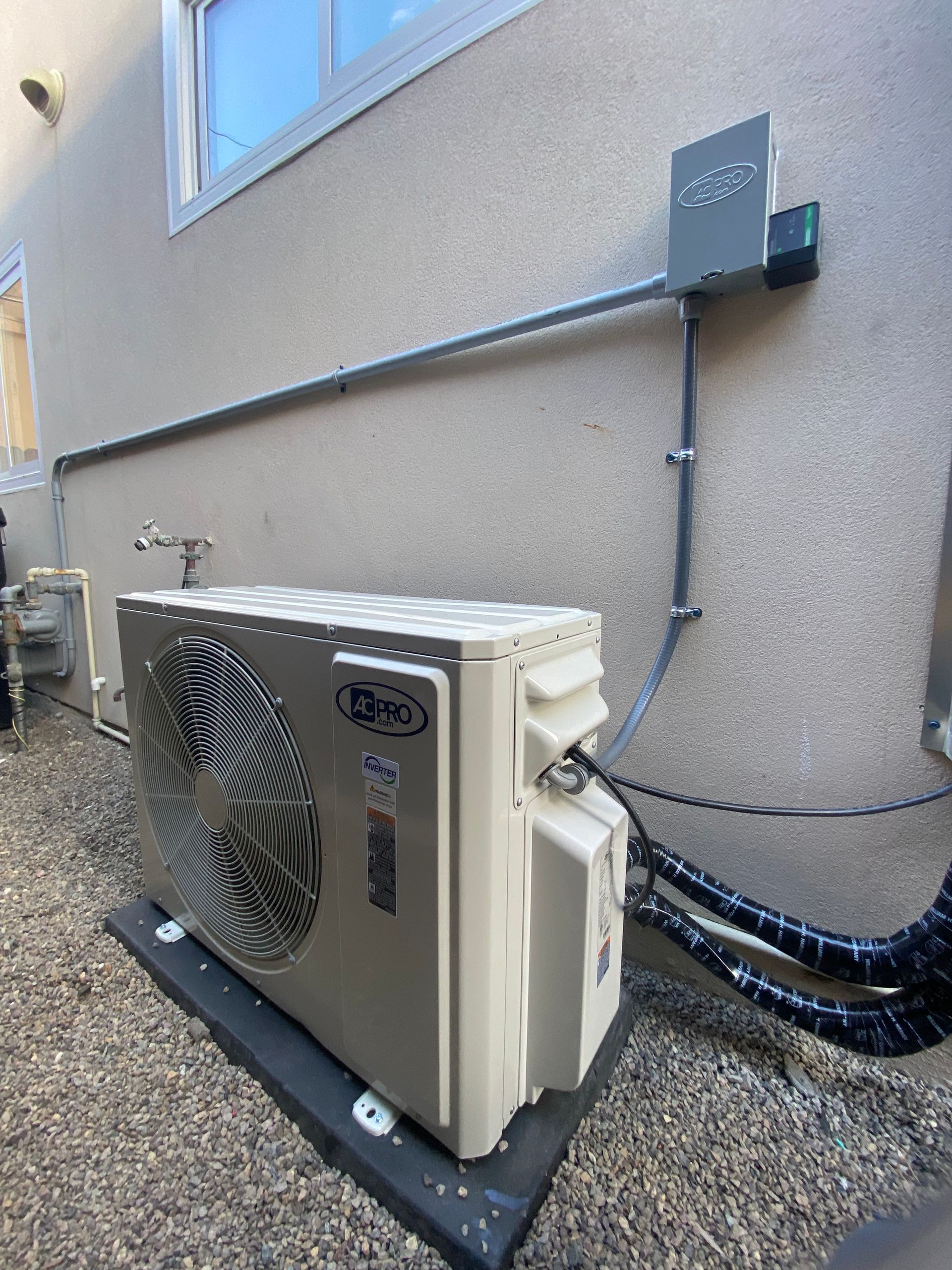 A large air conditioner is sitting on the side of a building.