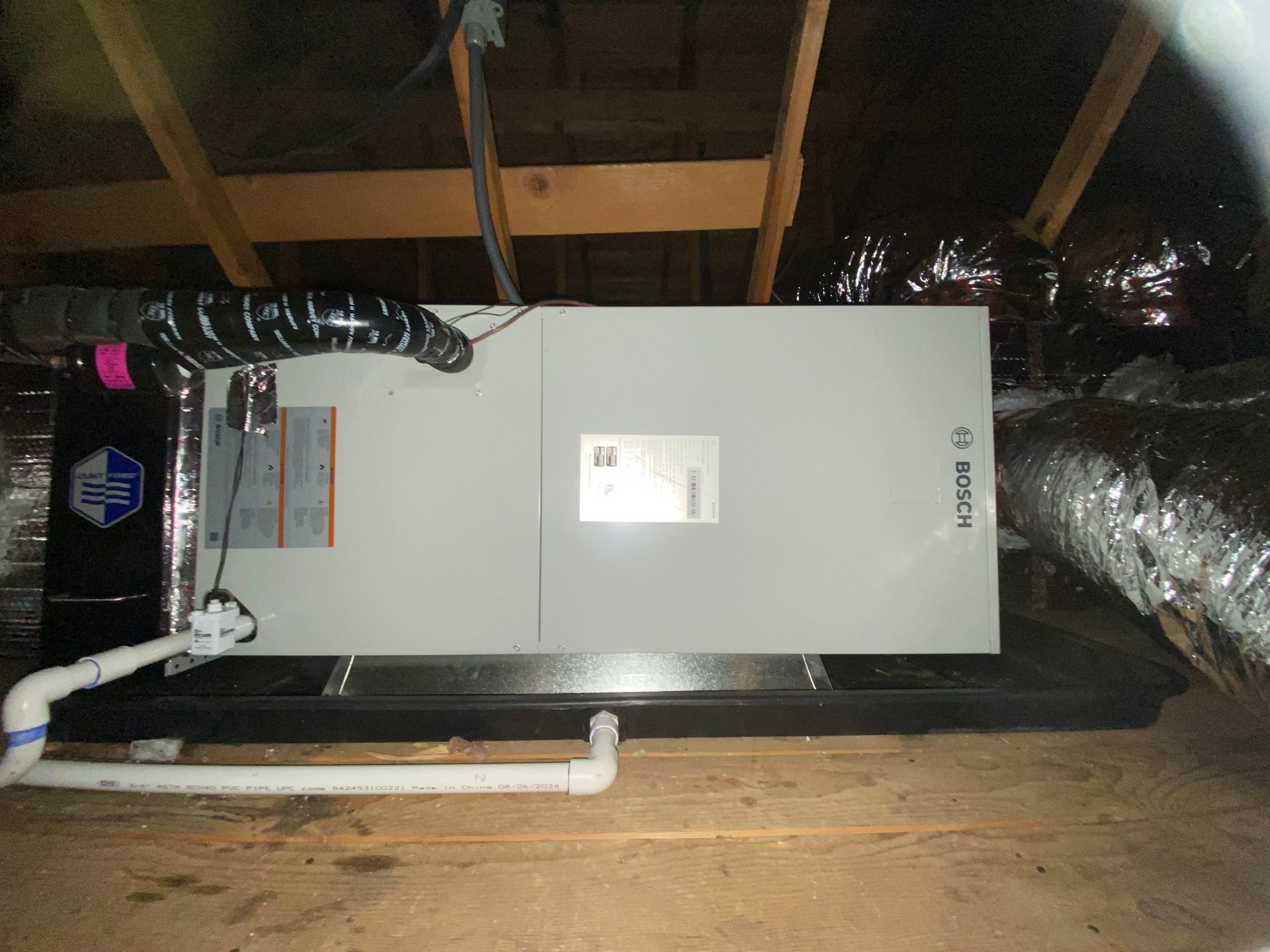 A bosch air conditioner is installed in the attic of a house.