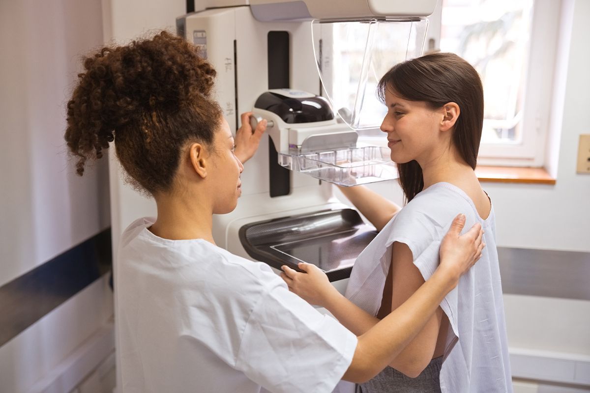 Woman preparing for her first mammogram at a radiology center.