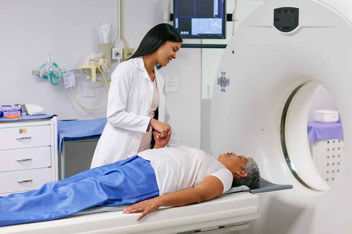 A patient about to enter an MRI scanner with a calm expression.