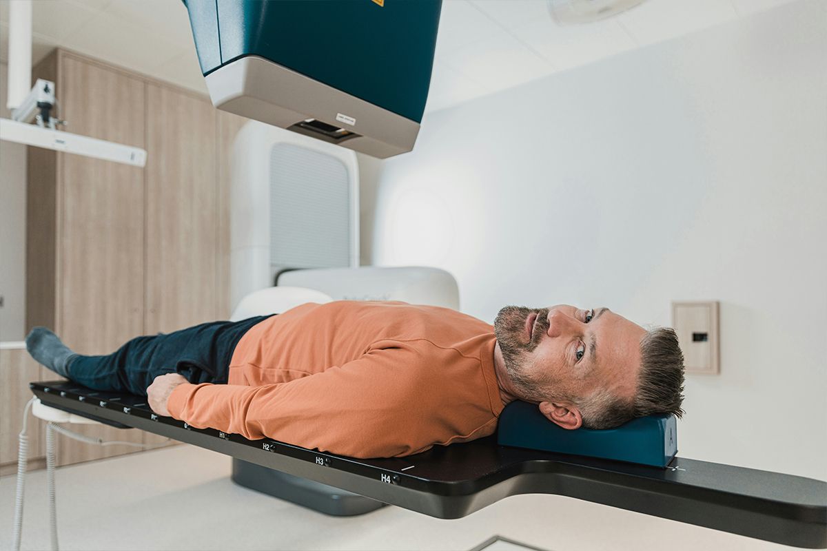 Male patient lying down for a CT scan.