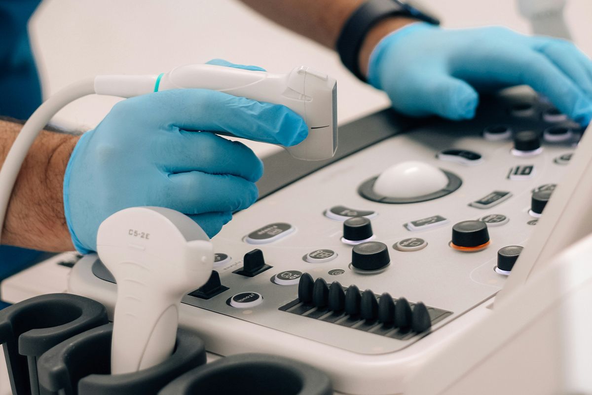 Doctor holding a transducer for an abdominal ultrasound