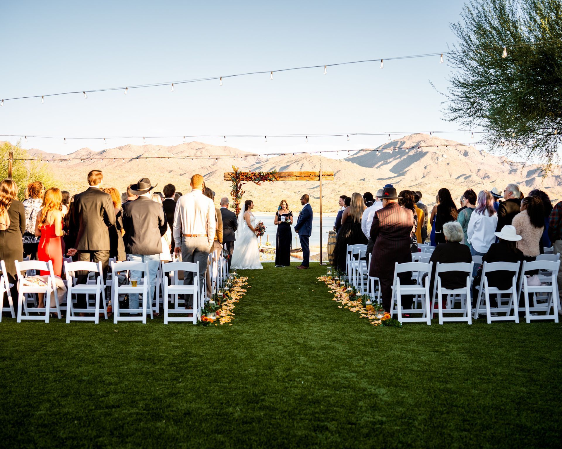 Bride and groom ceremony at Venue at the Cove with Bartlett Lake in the background