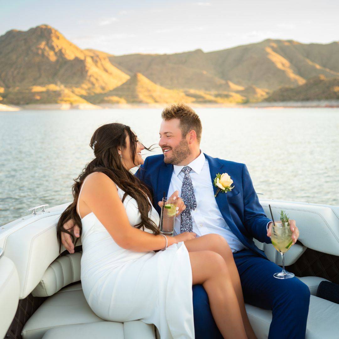 Bride and groom with drinks on boat ride part of the Yellow Cliffs Wedding Package from Venue at the Cove