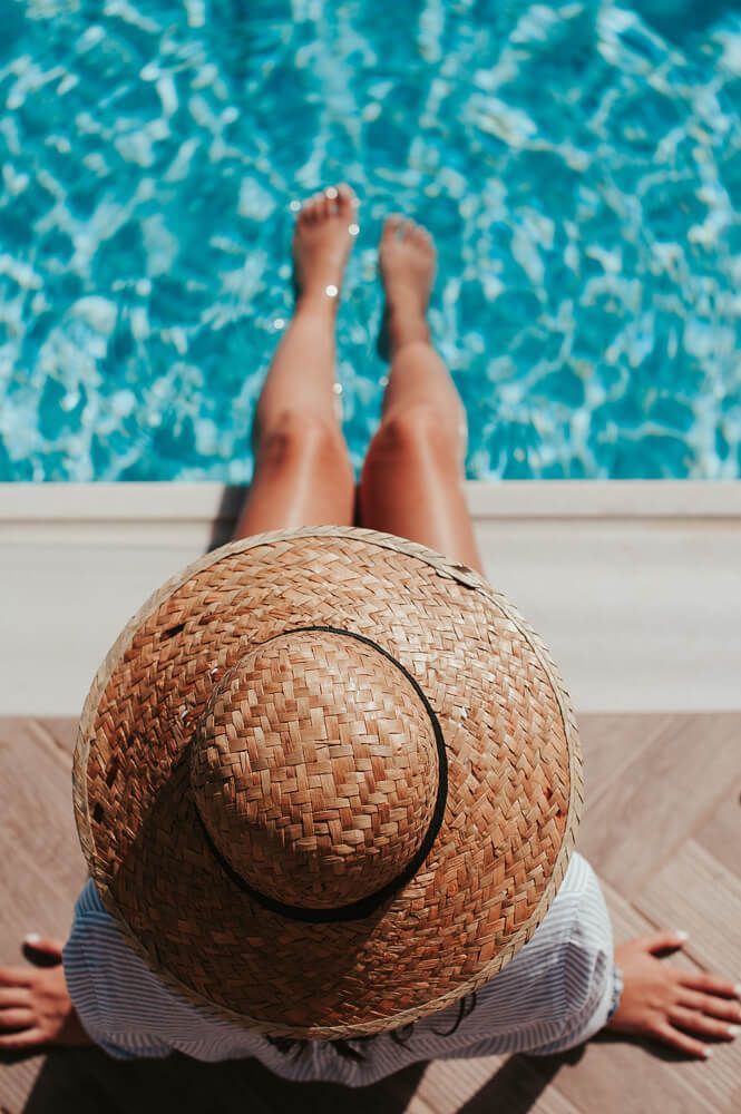 Woman's smooth legs dipping into pool - Laser hair removal for summer, Total Body Wellness, Brownsburg
