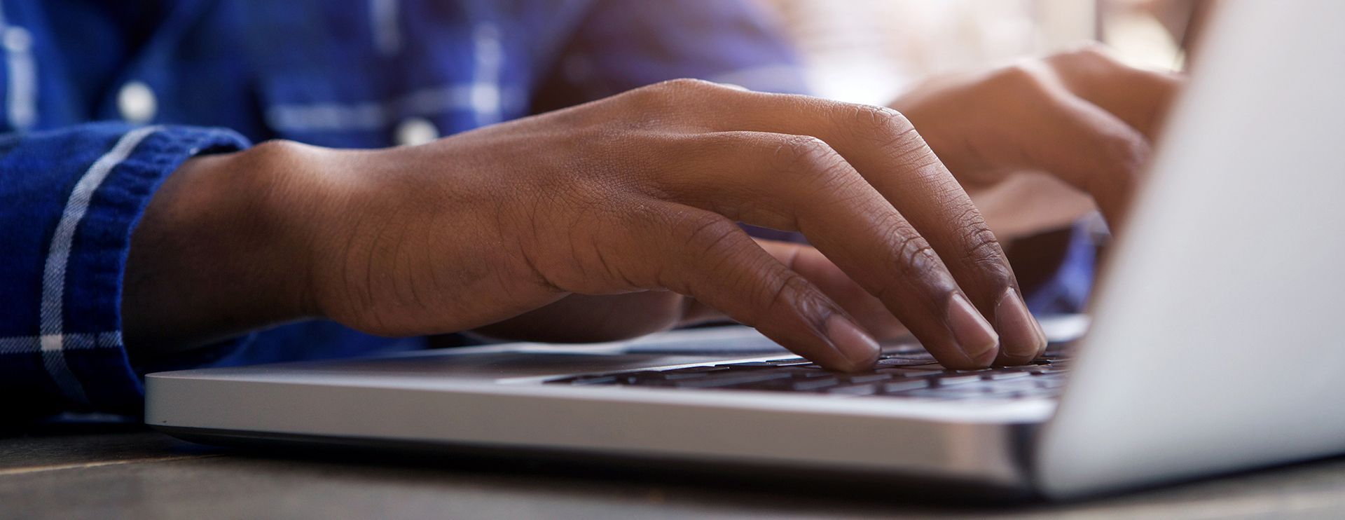a close up of a silver urn and a funeral service in the background