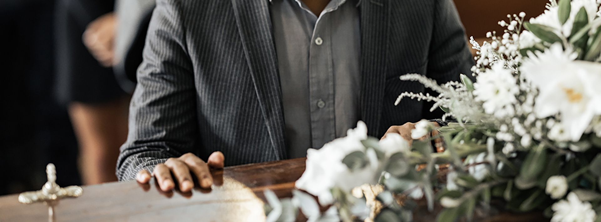 a silver urn filled with ashes is sitting on a table .