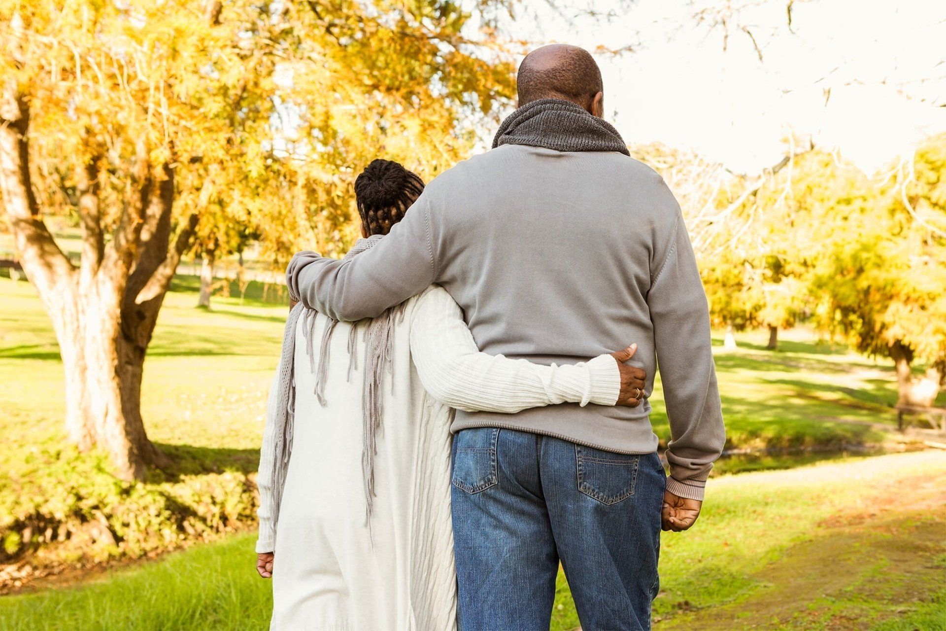 a man in a suit is comforting a woman at a funeral .
