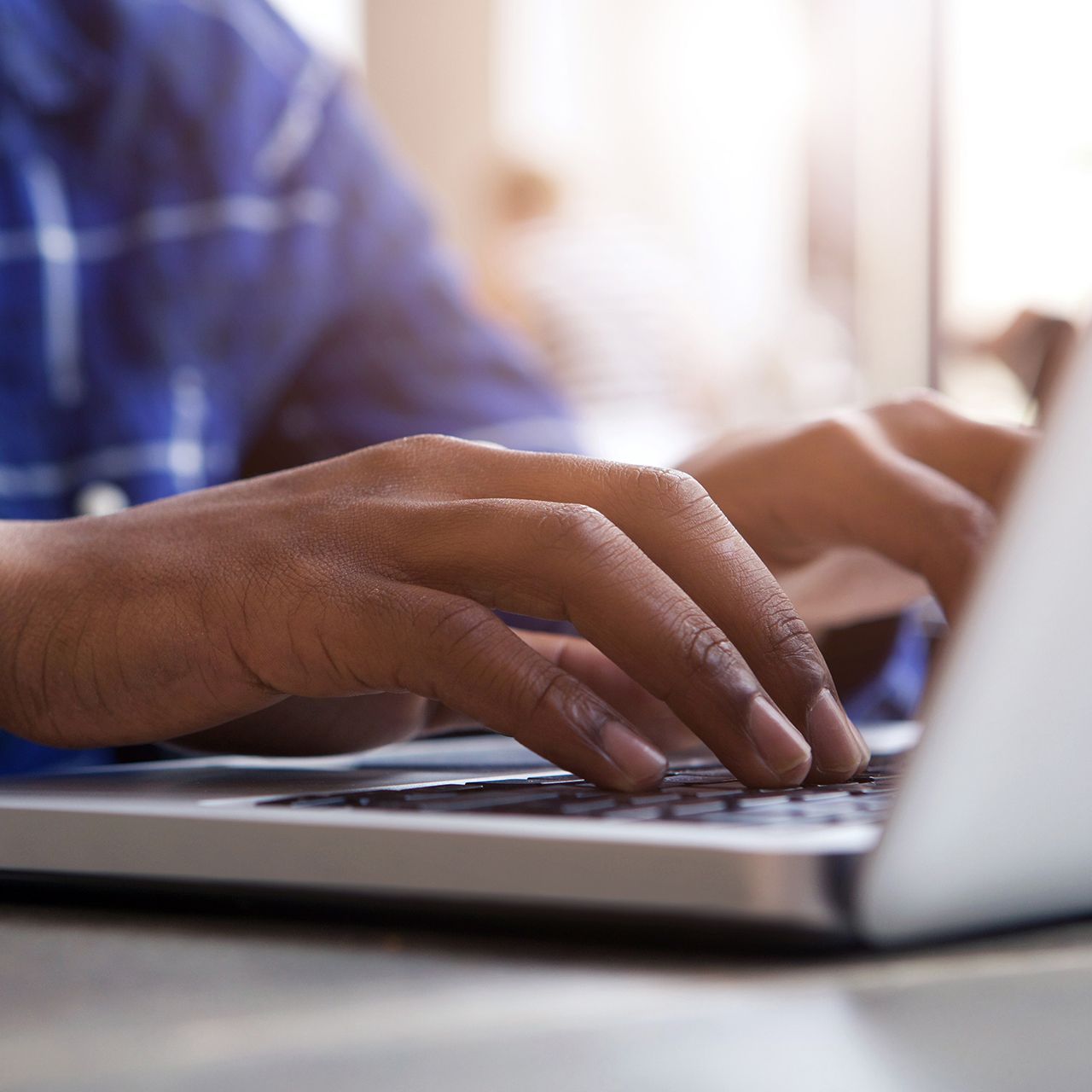 a metal urn is sitting on top of a lush green bush .