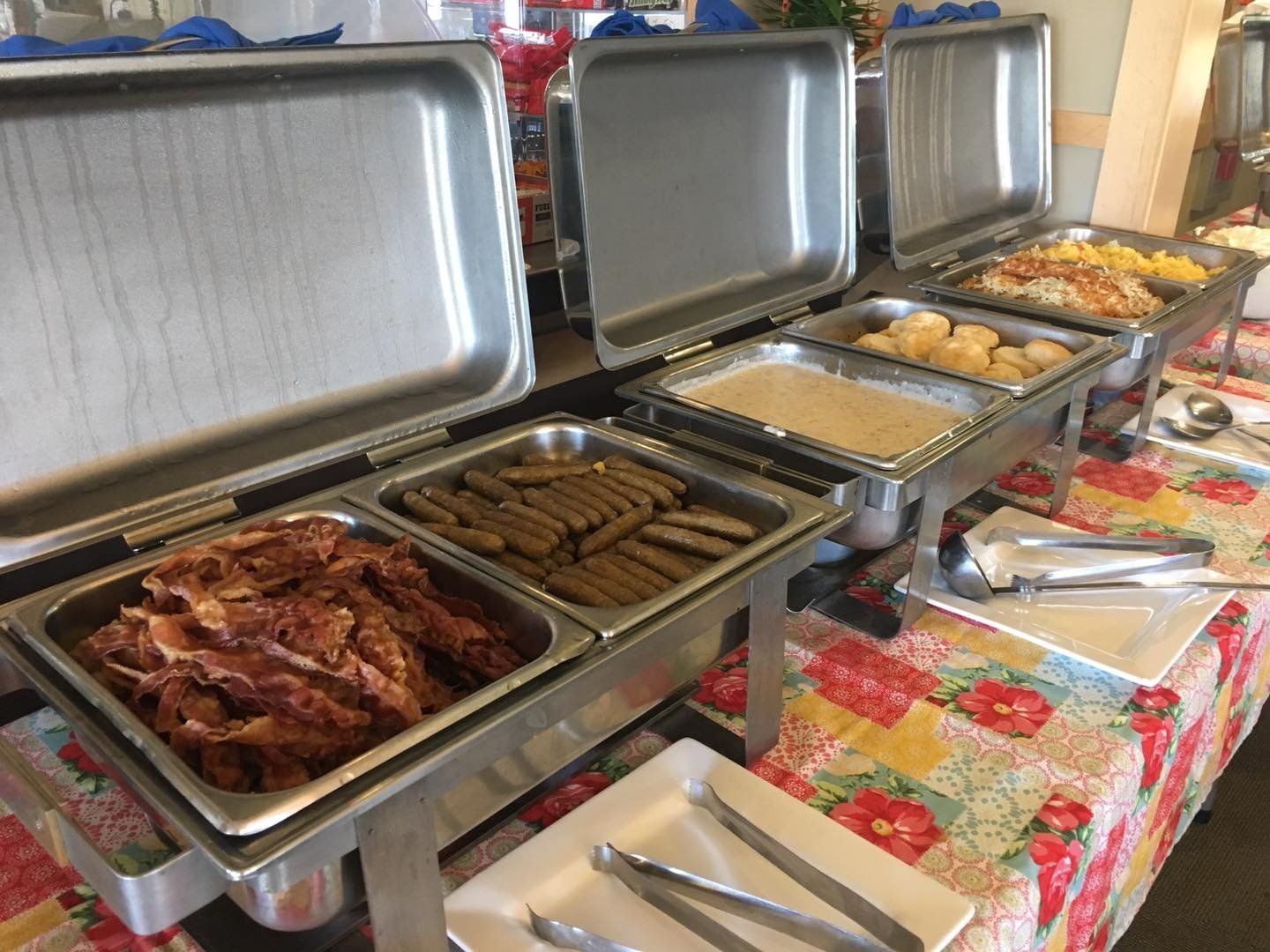 A buffet table with a variety of food on it.
