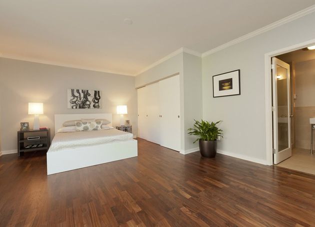 spacious wooden floored bedroom