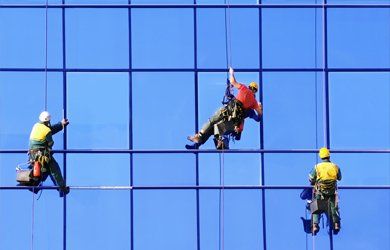 abseiling down a large window installation