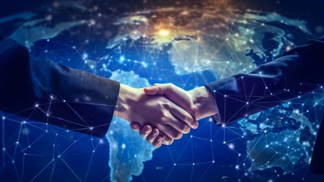 two people are shaking hands in front of a globe .