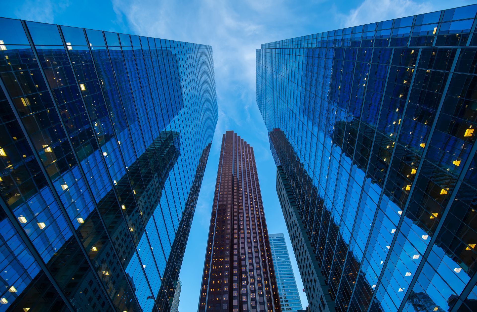 looking up at a row of tall buildings with a blue sky in the background .