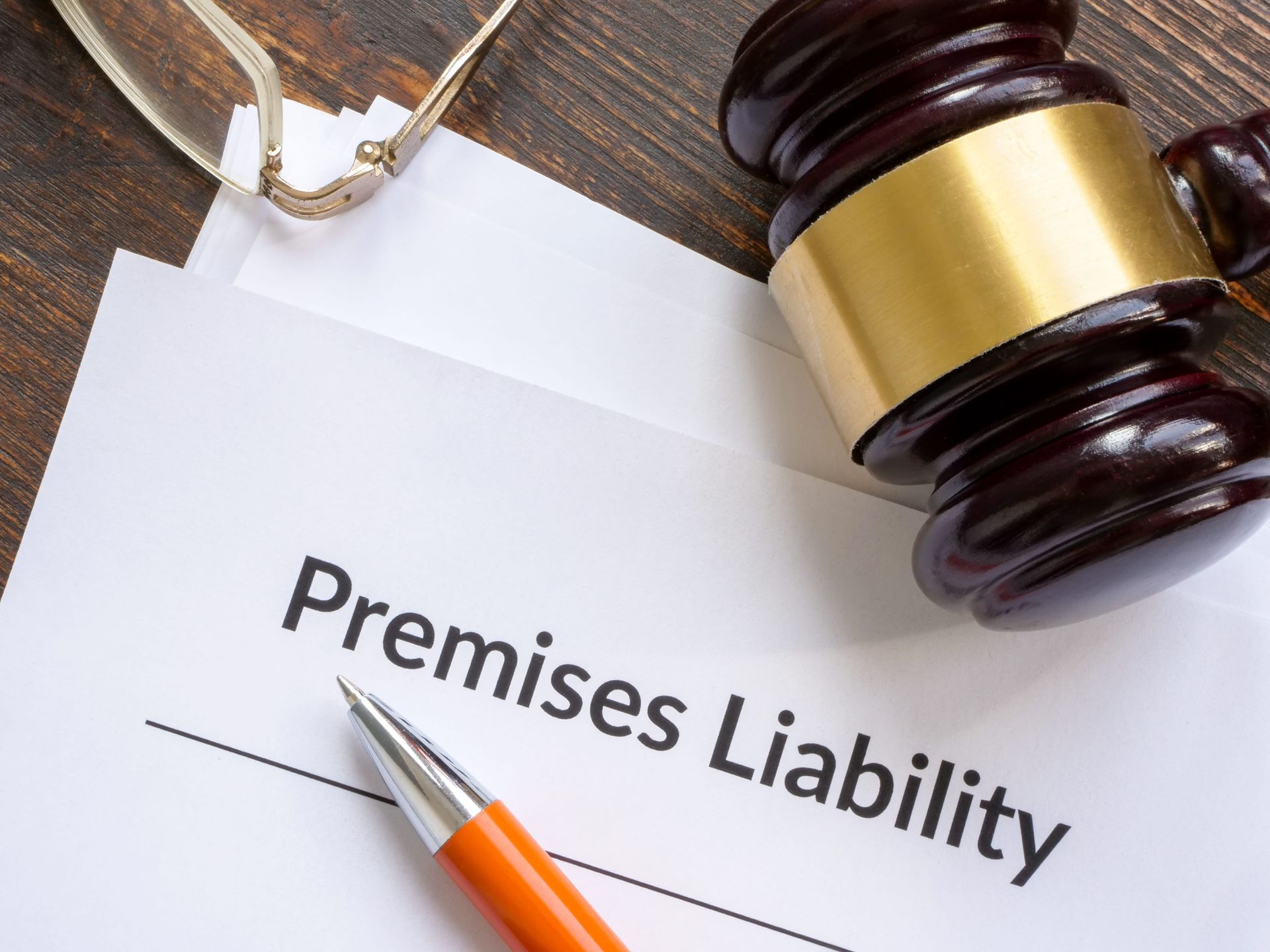 “Premises Liability” document with a gavel and pen on a desk