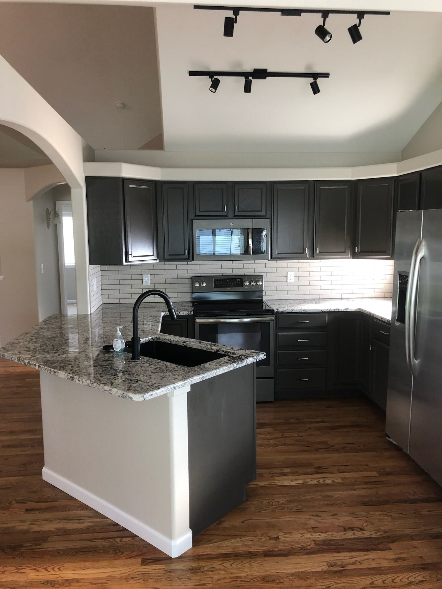 A kitchen with stainless steel appliances and granite counter tops