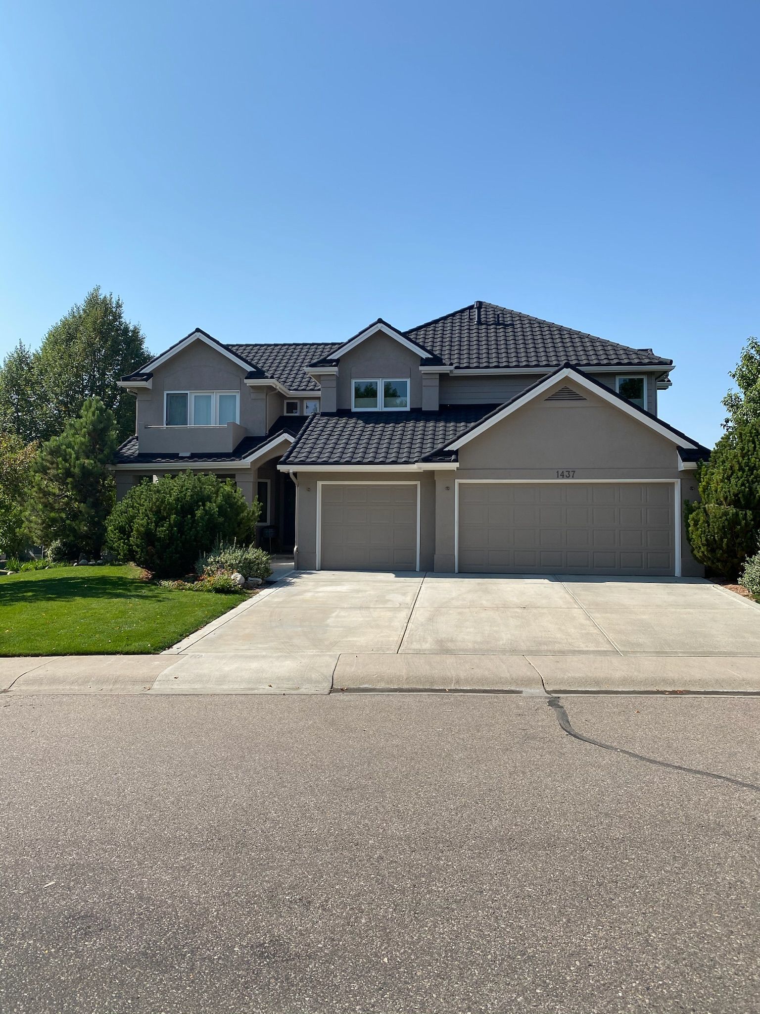 A large house with two garages and a driveway