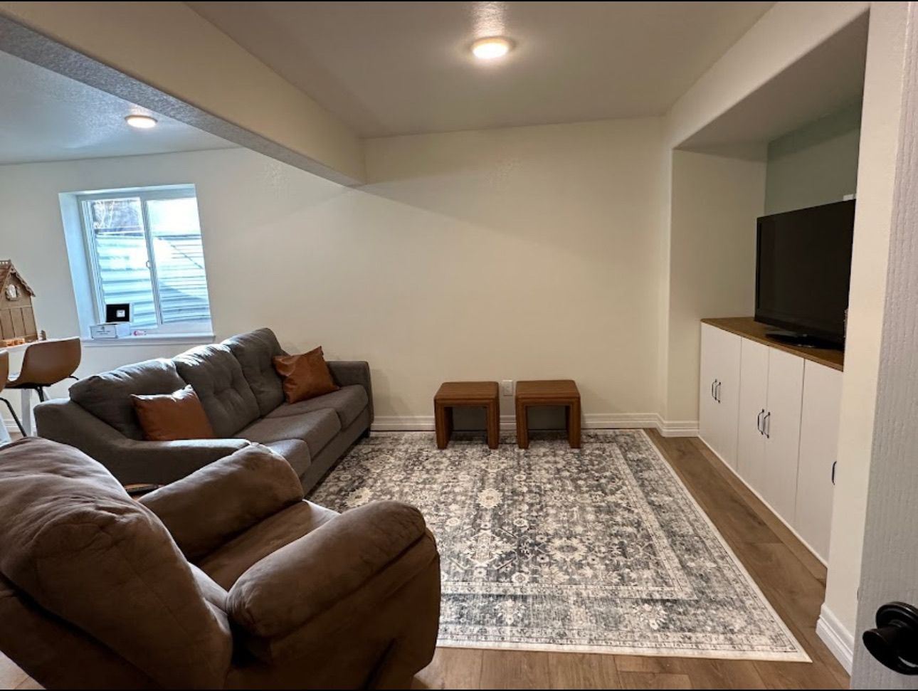 A living room with a couch , chair and television