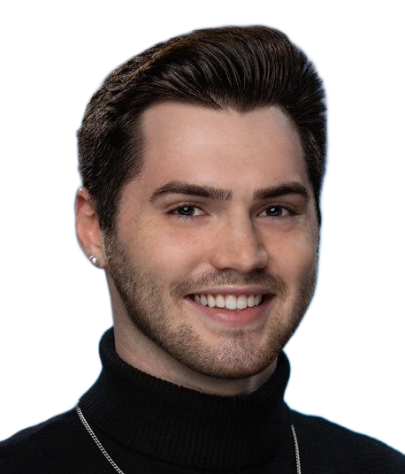Young man with dark hair smiles at the camera, wearing a black turtleneck and silver earring.