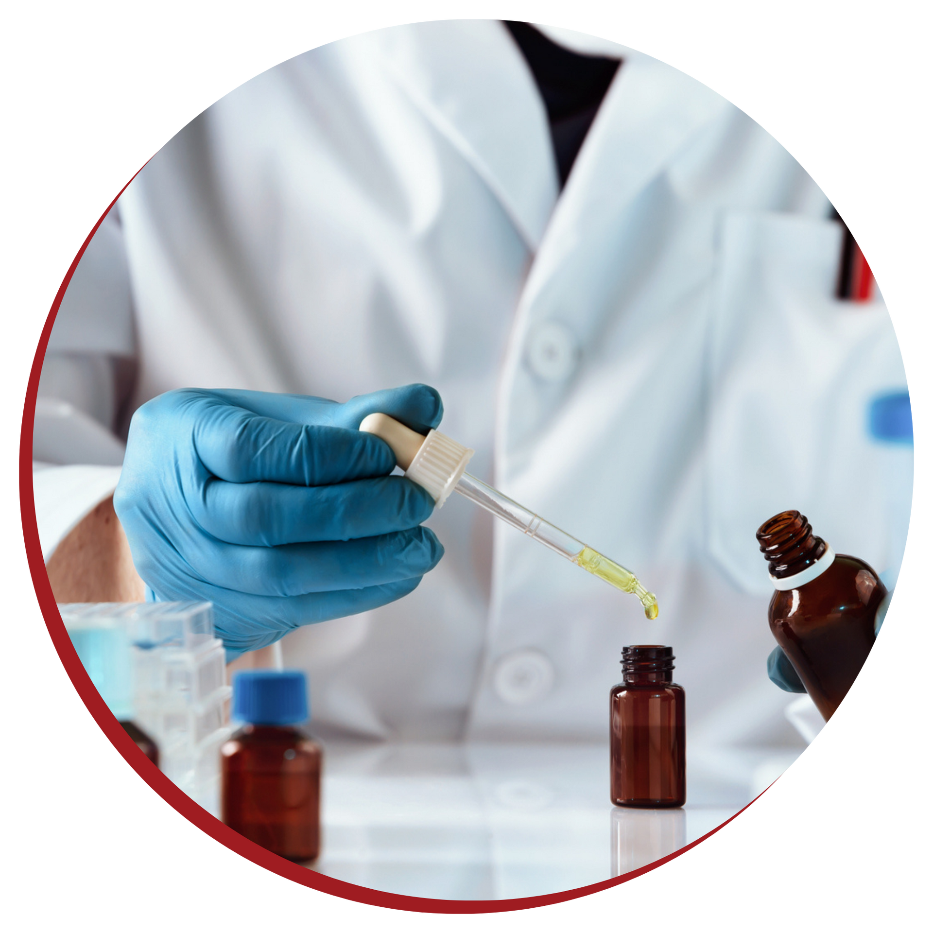 A scientist is holding a pipette and pouring liquid into a bottle.