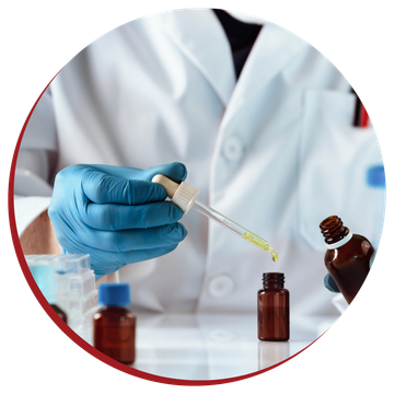 A scientist is holding a pipette and pouring liquid into a bottle.