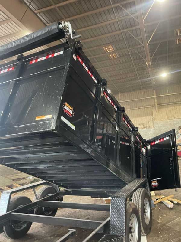 a dump trailer with the word trucks on the side