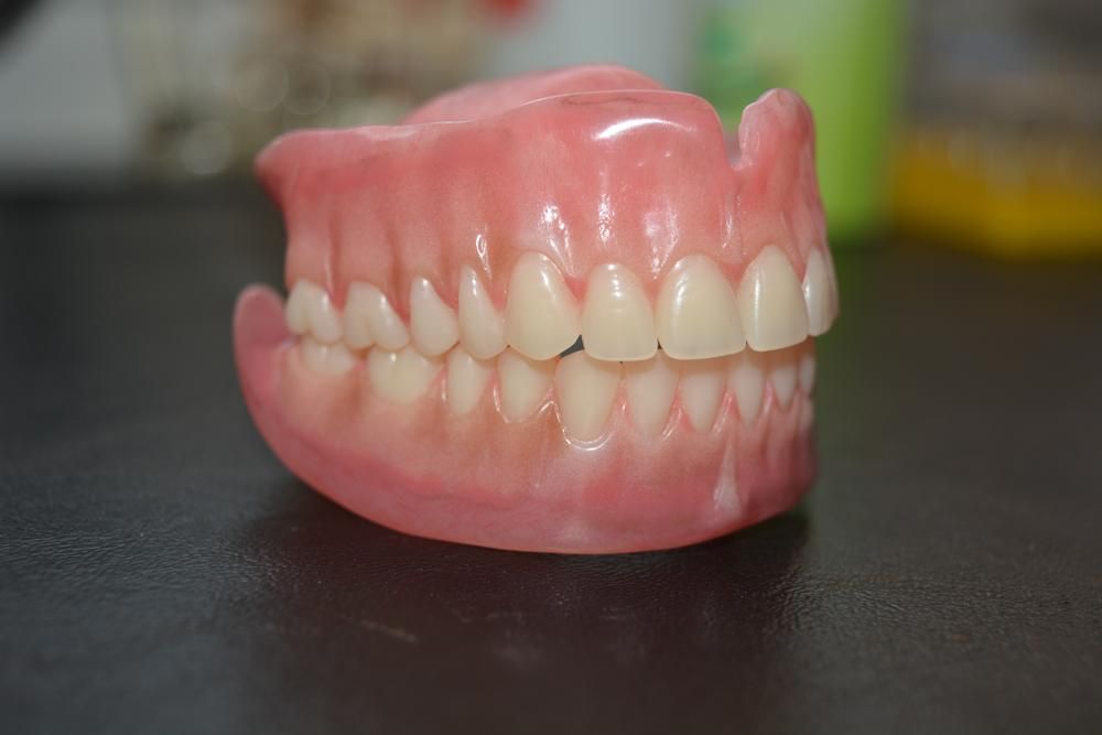 A Close up Of a Denture on A Table — Peter McLennan Denture Clinic in Grafton, NSW