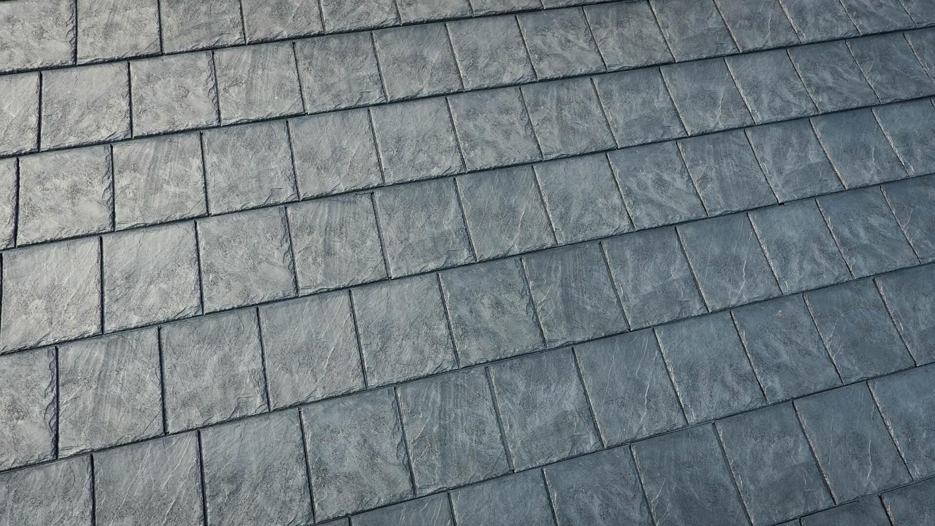 A close up of a gray tile roof