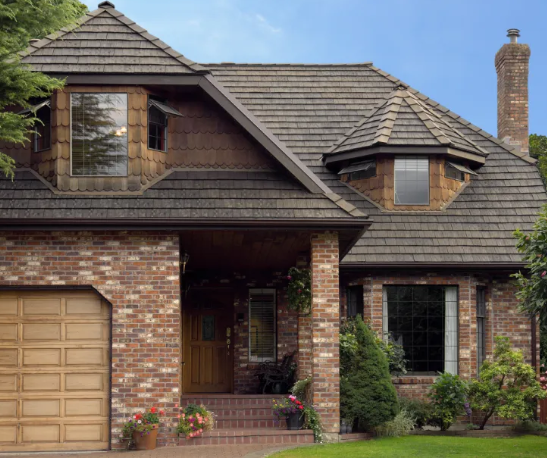 A large brick house with a wooden garage door