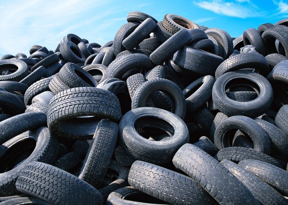 a pile of tires with a blue sky in the background