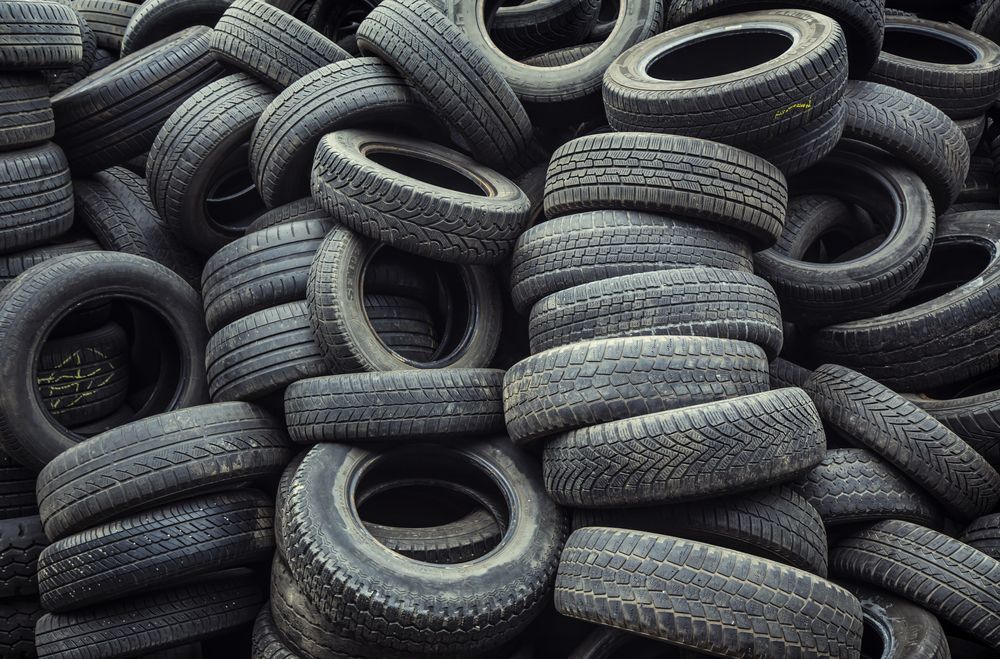 a pile of old tires are stacked on top of each other .
