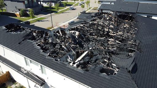 An aerial view of a house that has been damaged by a fire.