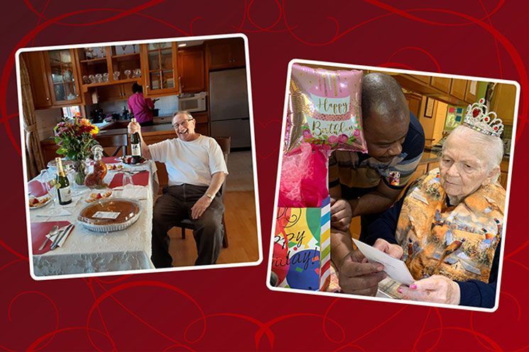 A man is sitting at a table holding a bottle of wine and a woman is holding a balloon.