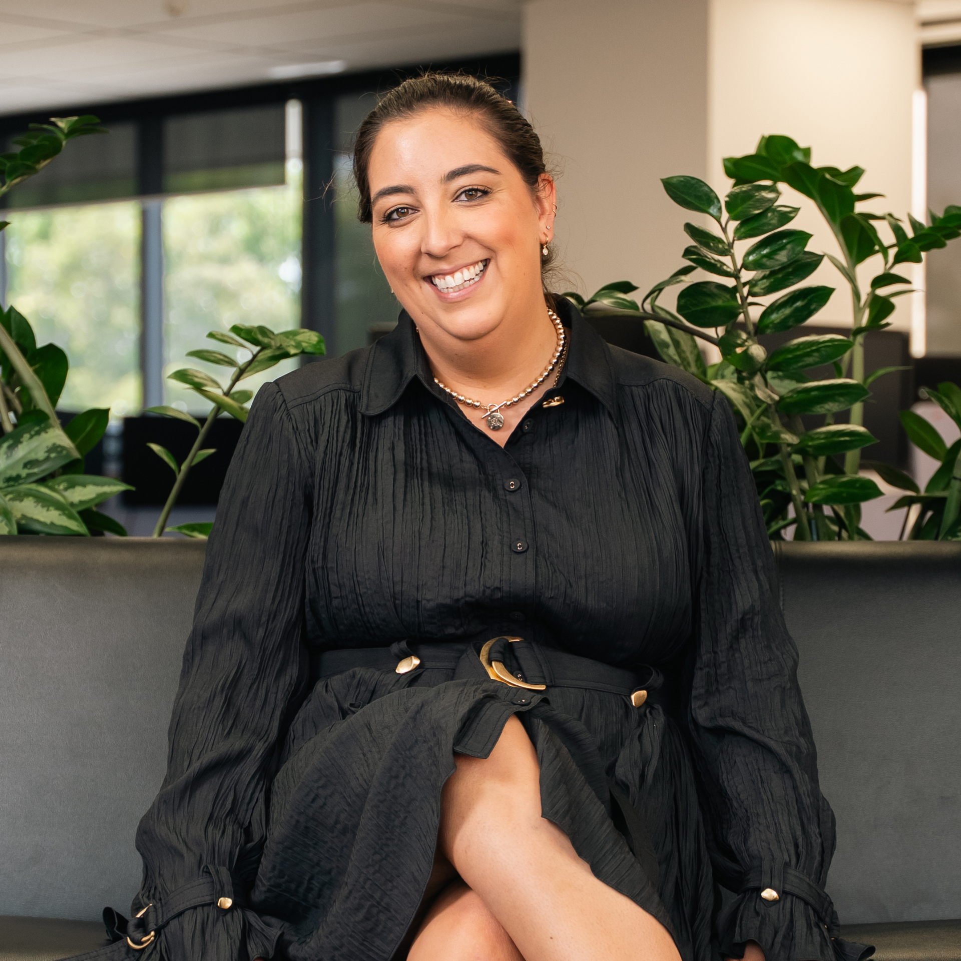 Kymberly Jones smiling on couch