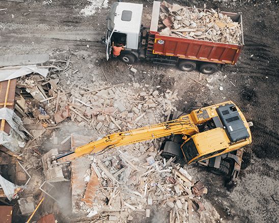 an aerial view of a construction site with a bulldozer and a dump truck .