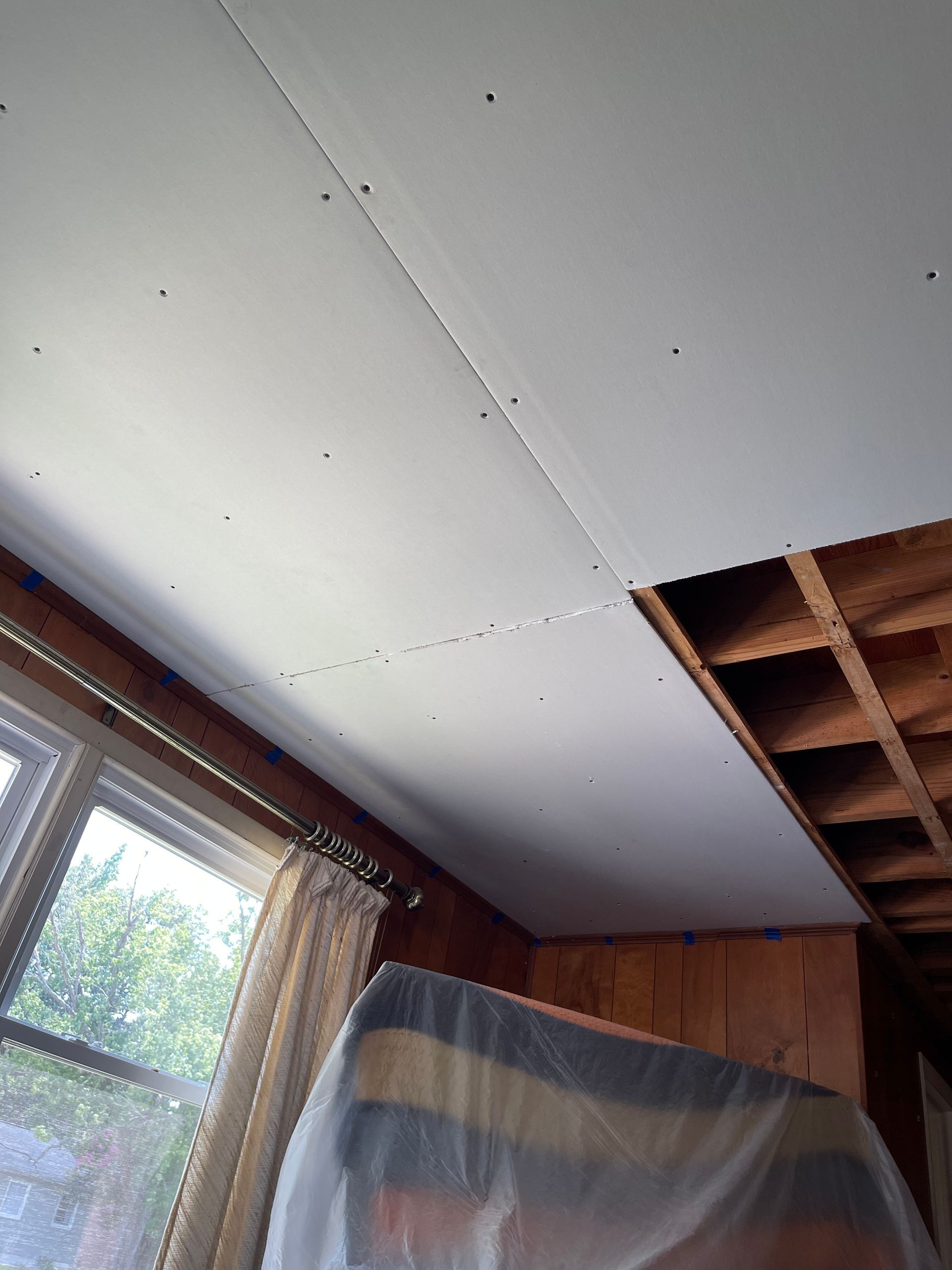 A room with a ceiling that is being remodeled