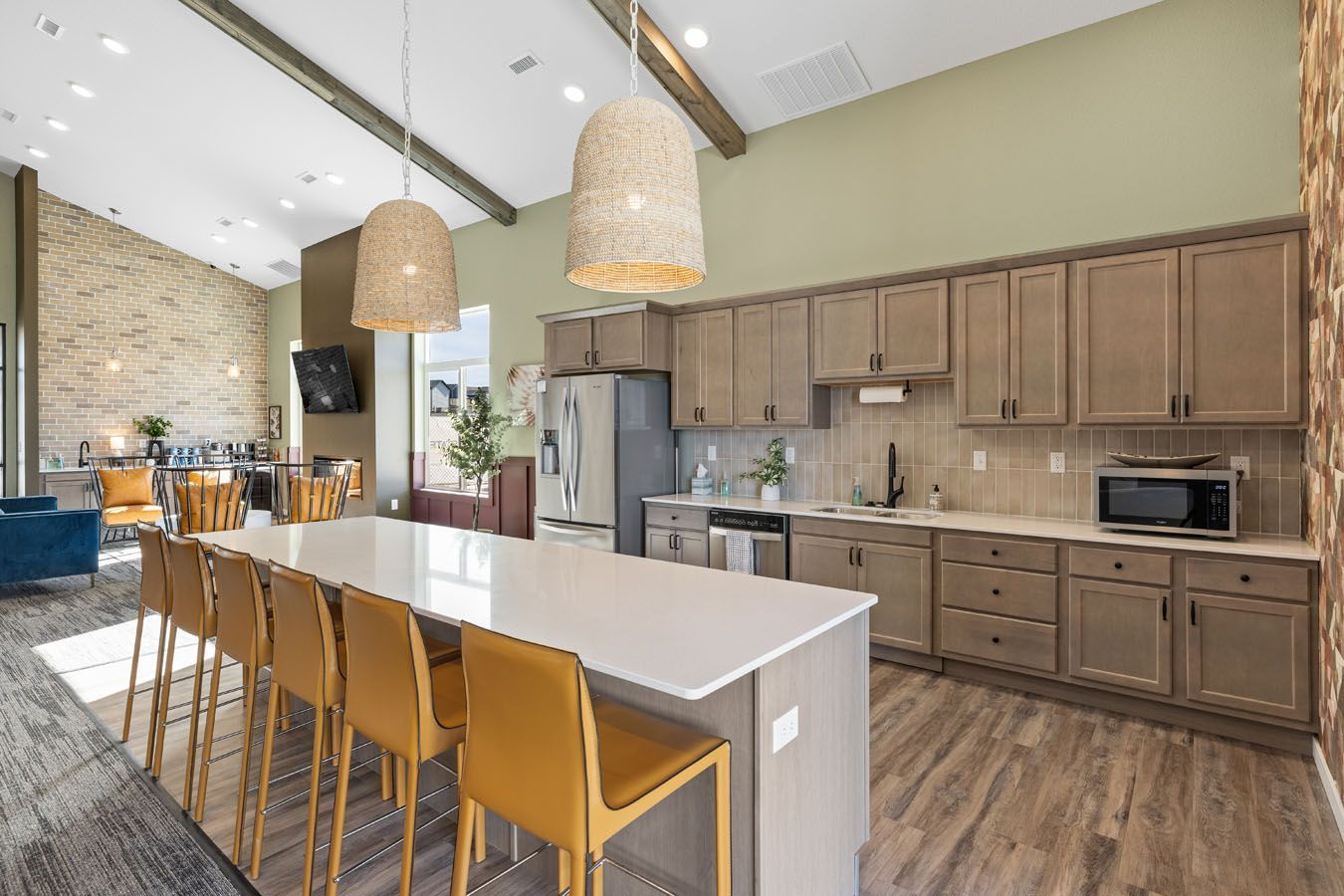 a kitchen with a long island and a lot of chairs .