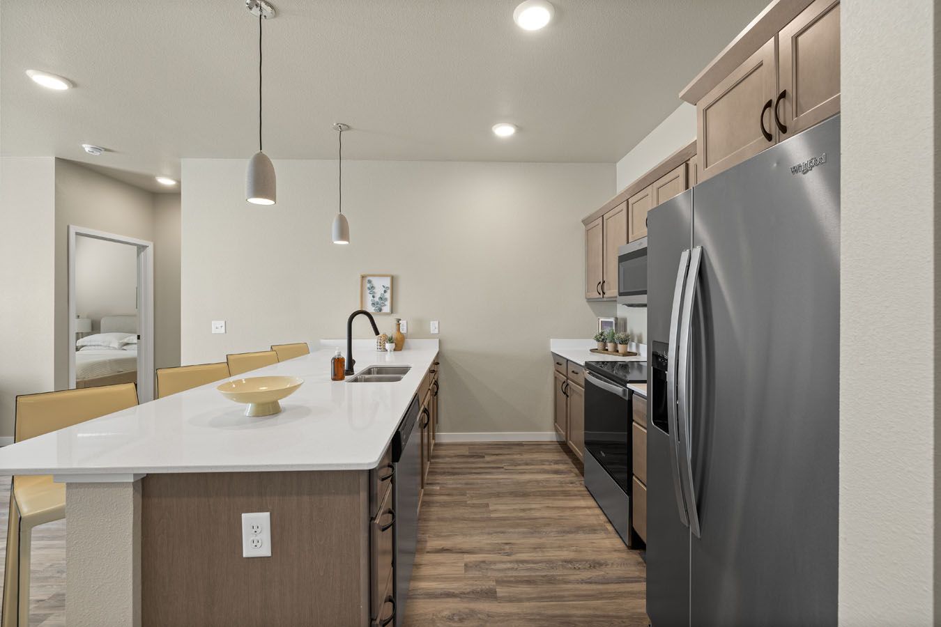 a kitchen with stainless steel appliances and a large island .