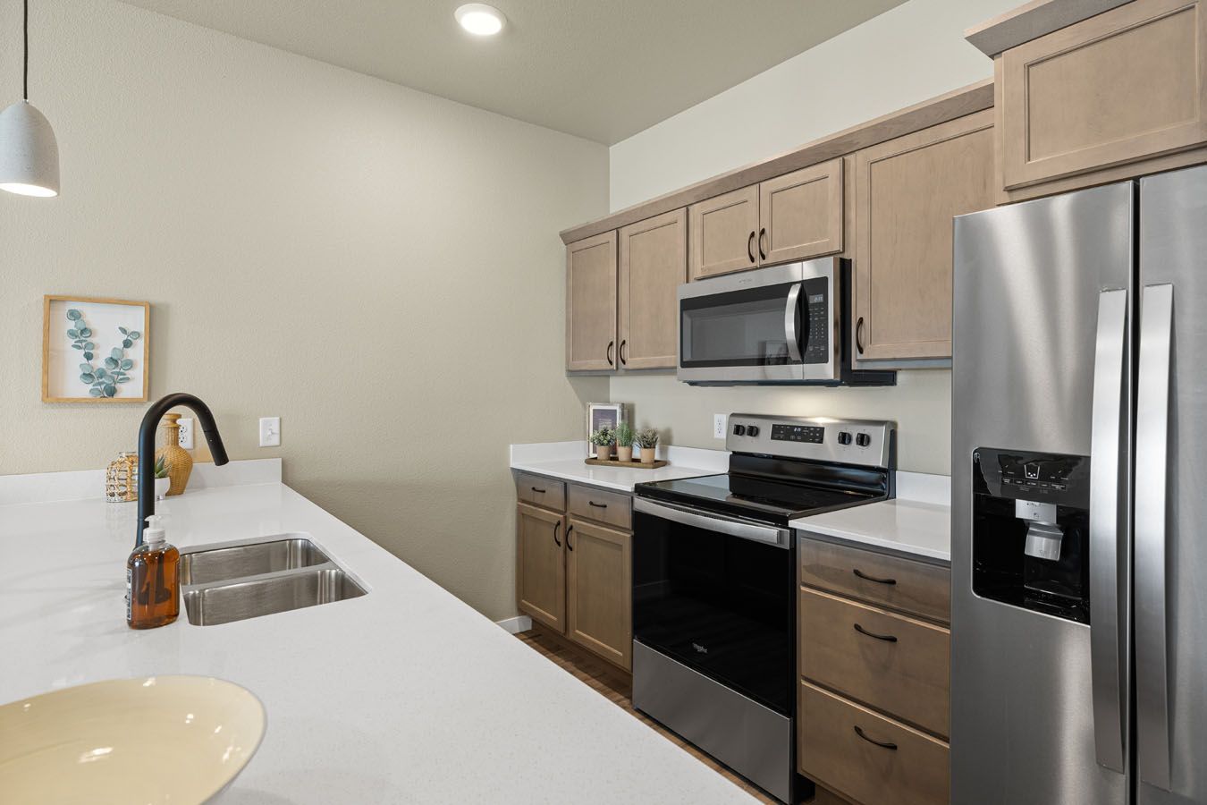 a kitchen with stainless steel appliances and wooden cabinets .