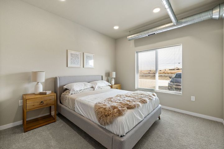 a bedroom with a large bed and a window .