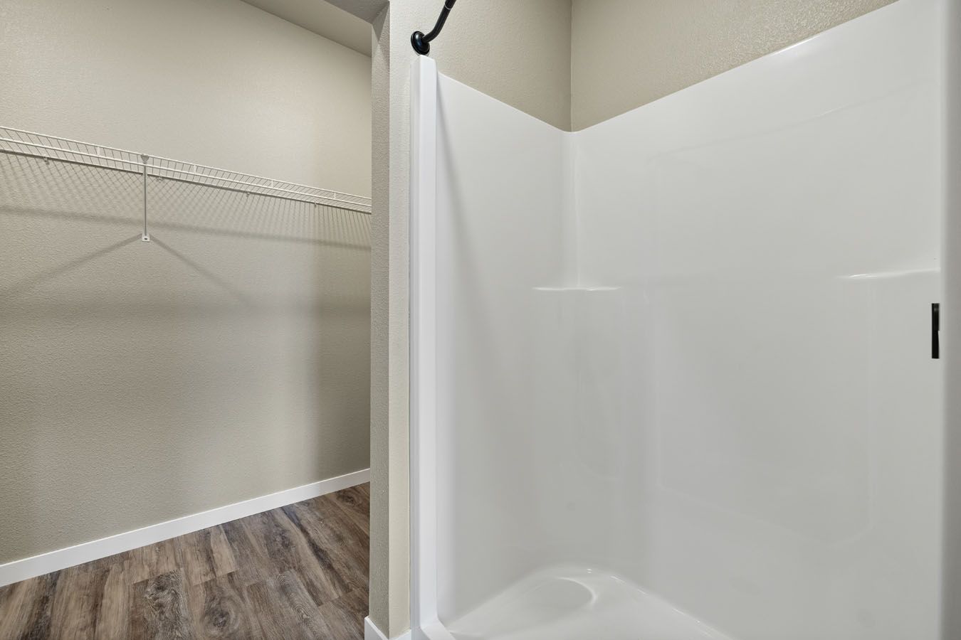a bathroom with a walk in closet and a shower stall .