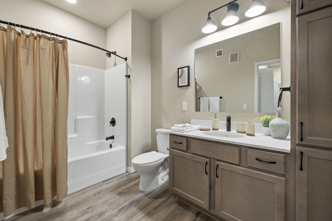 a bathroom with a toilet , sink , tub and shower .