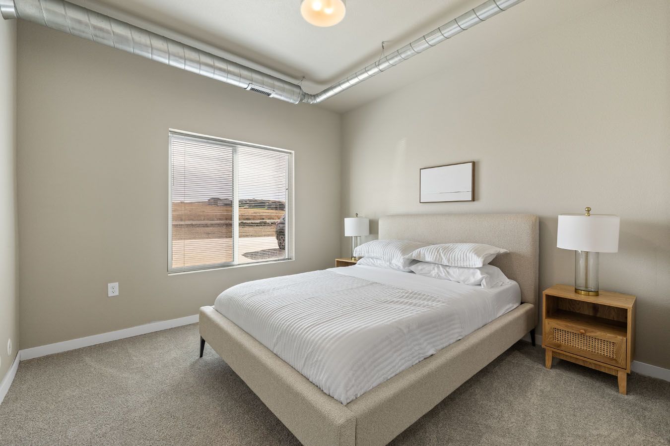 there is a large bed in the middle of the room .