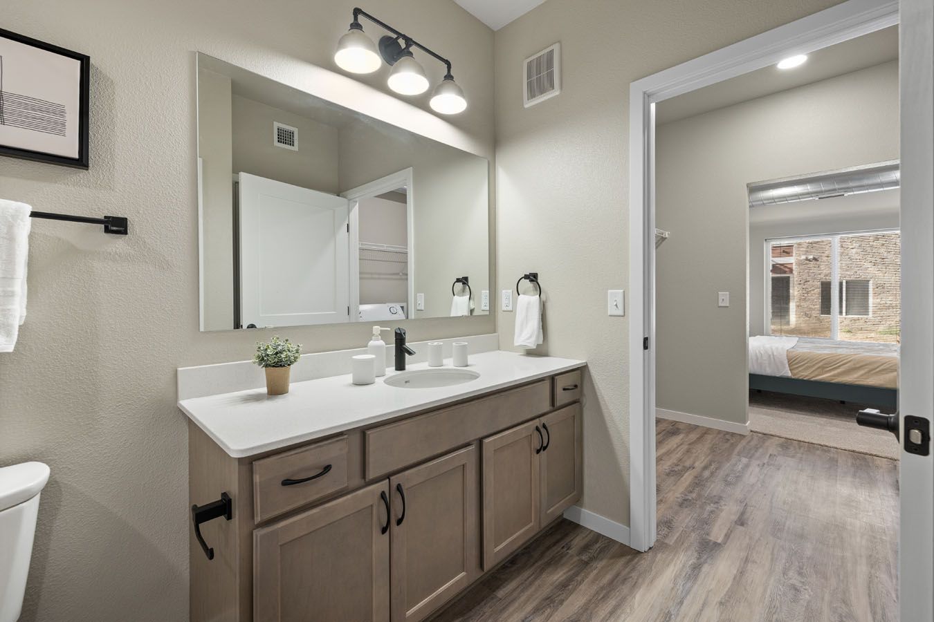 a bathroom with a sink , mirror and toilet .